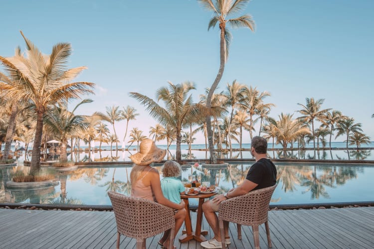 Family relaxing by the pool